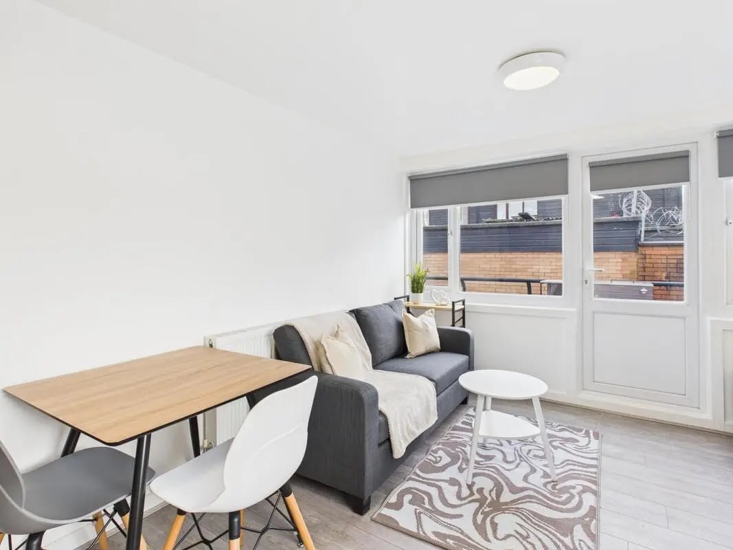 Sofa table chairs rug and rug living room at 2 Bedroom House at Flat 1, Grove Street Studios, The Groves in Liverpool Student Accommodation