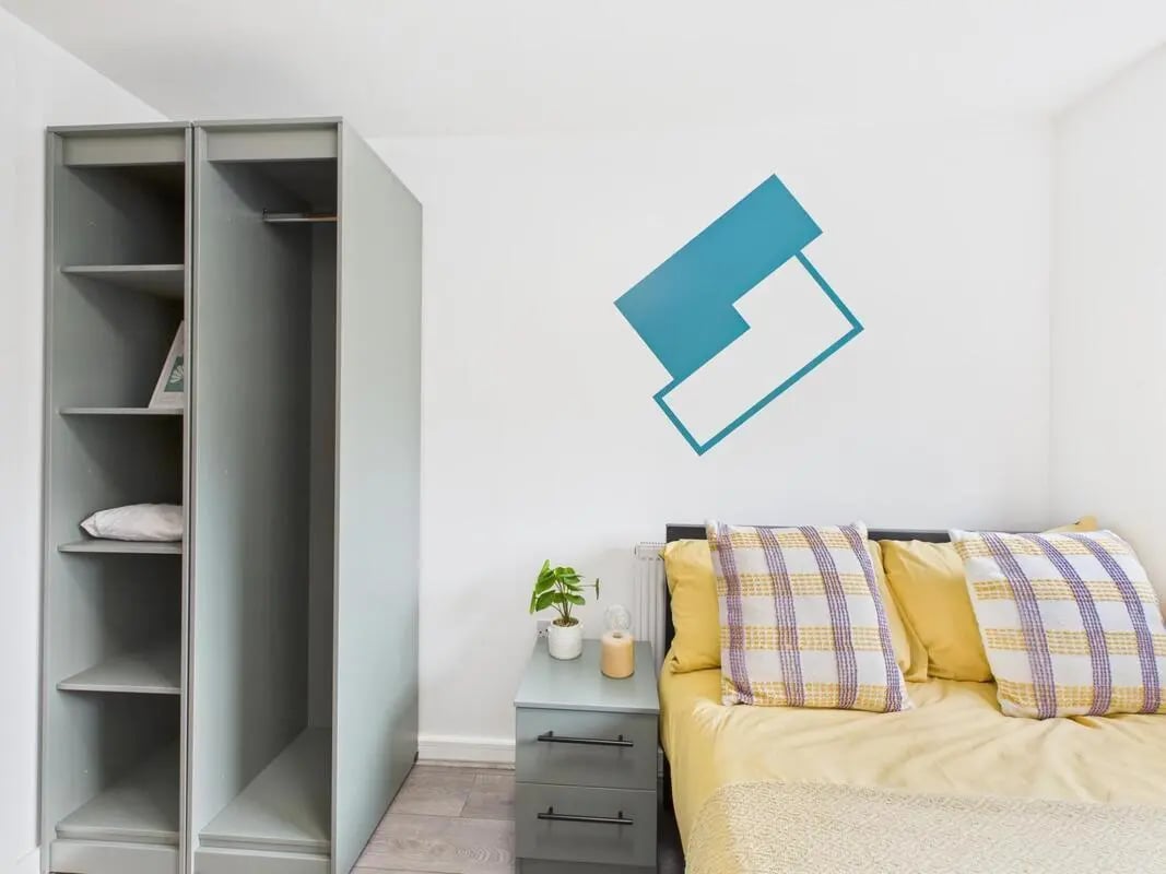 Wardrobe bedside table bed with pillows Bedroom at 2 Bedroom House at Flat 1, Grove Street Studios, The Groves in Liverpool Student Accommodation
