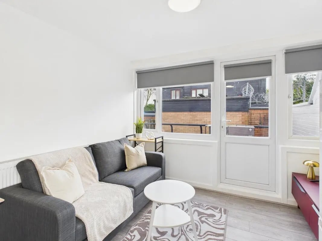 Grey sofa white rug round coffee table living room at 2 Bedroom House at Flat 8, Grove Street Studios, The Groves in Liverpool Student Accommodation