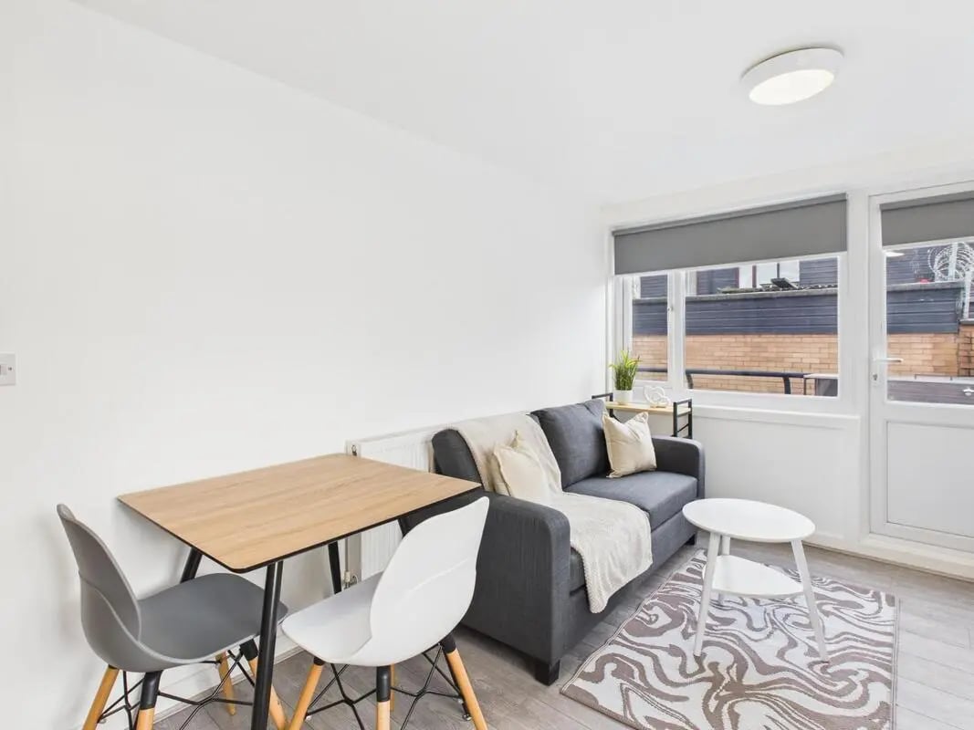 Sofa dining table rug and chairs living room at 2 Bedroom House at Flat 8, Grove Street Studios, The Groves in Liverpool Student Accommodation