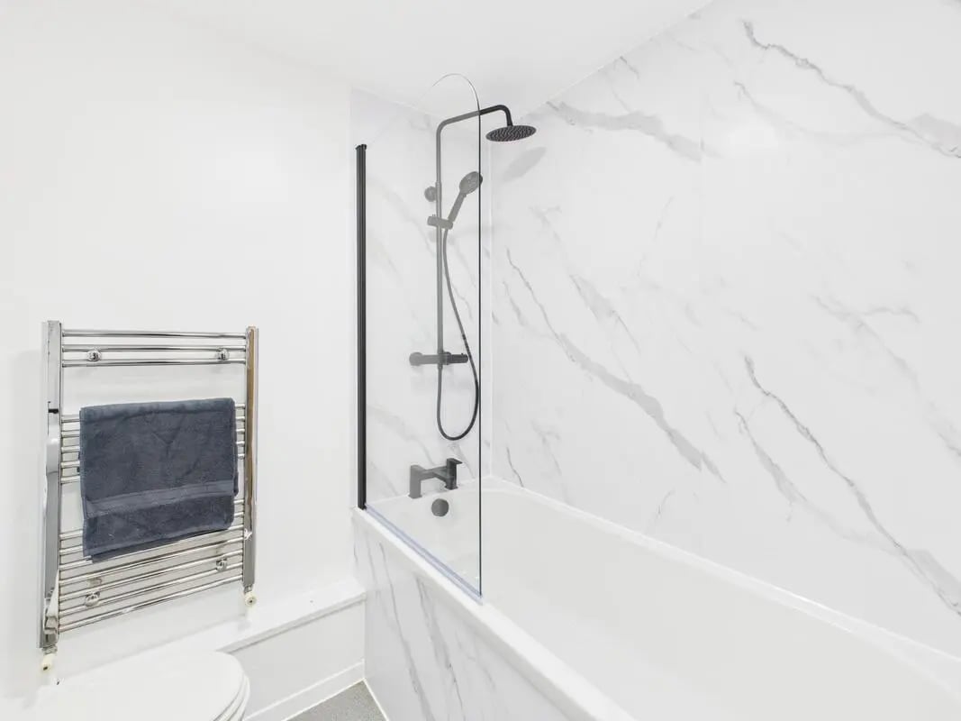 Chrome towel rail with grey towel and bathtub bathroom at 2 Bedroom House at Flat 8, Grove Street Studios, The Groves in Liverpool Student Accommodation