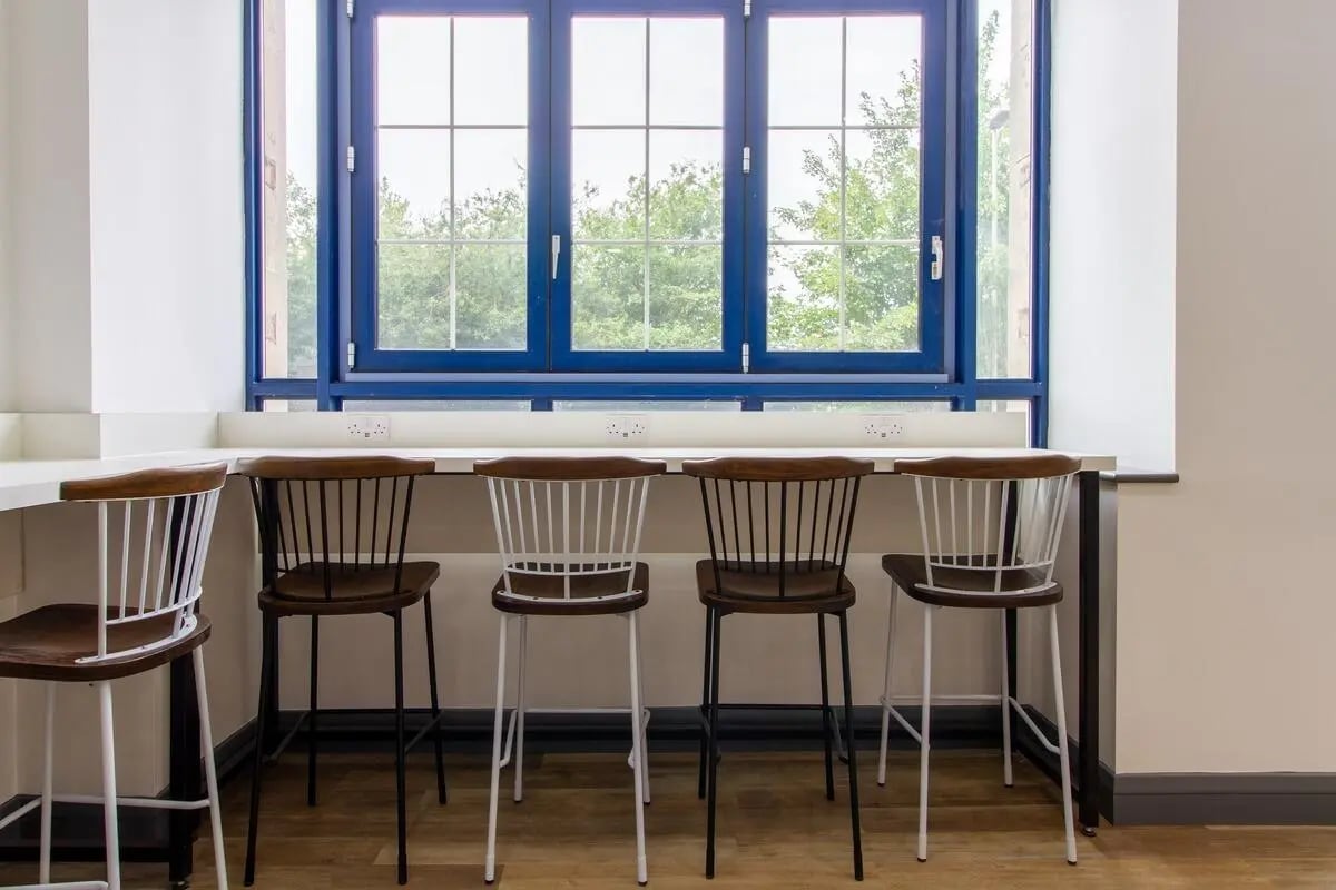 Bar stools at counter by blue window study area at Ben Russell Court in Leicester Student Accommodation