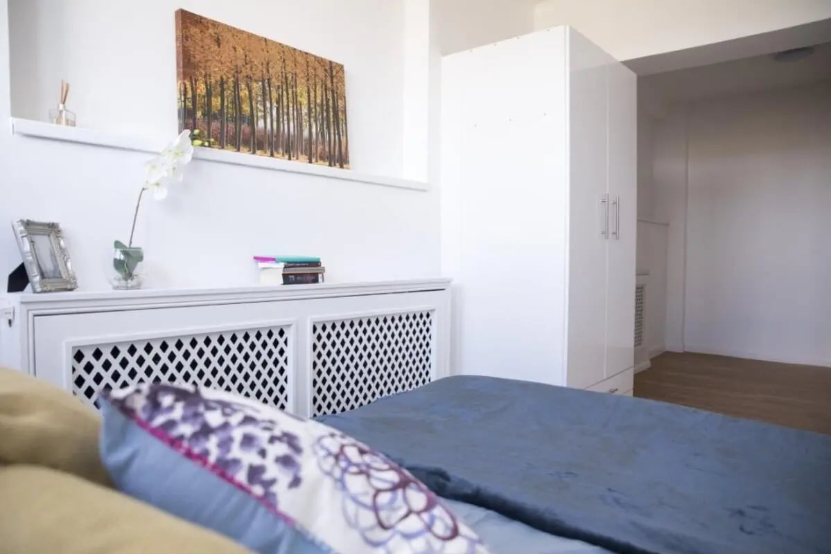 Artwork books diffuser white wardrobe bed bedroom at Portobello Garrow House in London Student Accommodation