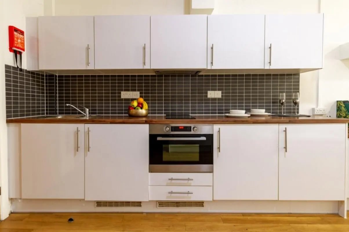 White cabinets oven sink fruit bowl kitchen at Portobello Garrow House in London Student Accommodation