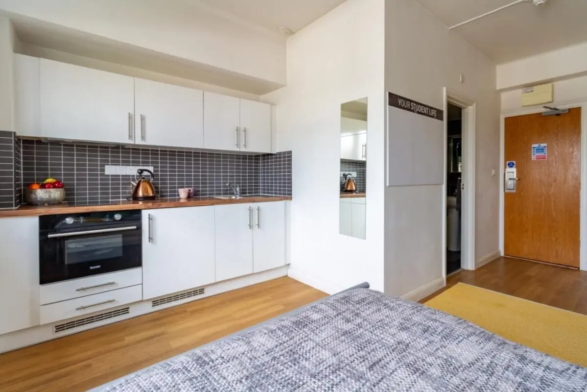 Compact kitchen with oven sink kettle and cabinets kitchen at Portobello Garrow House in London Student Accommodation
