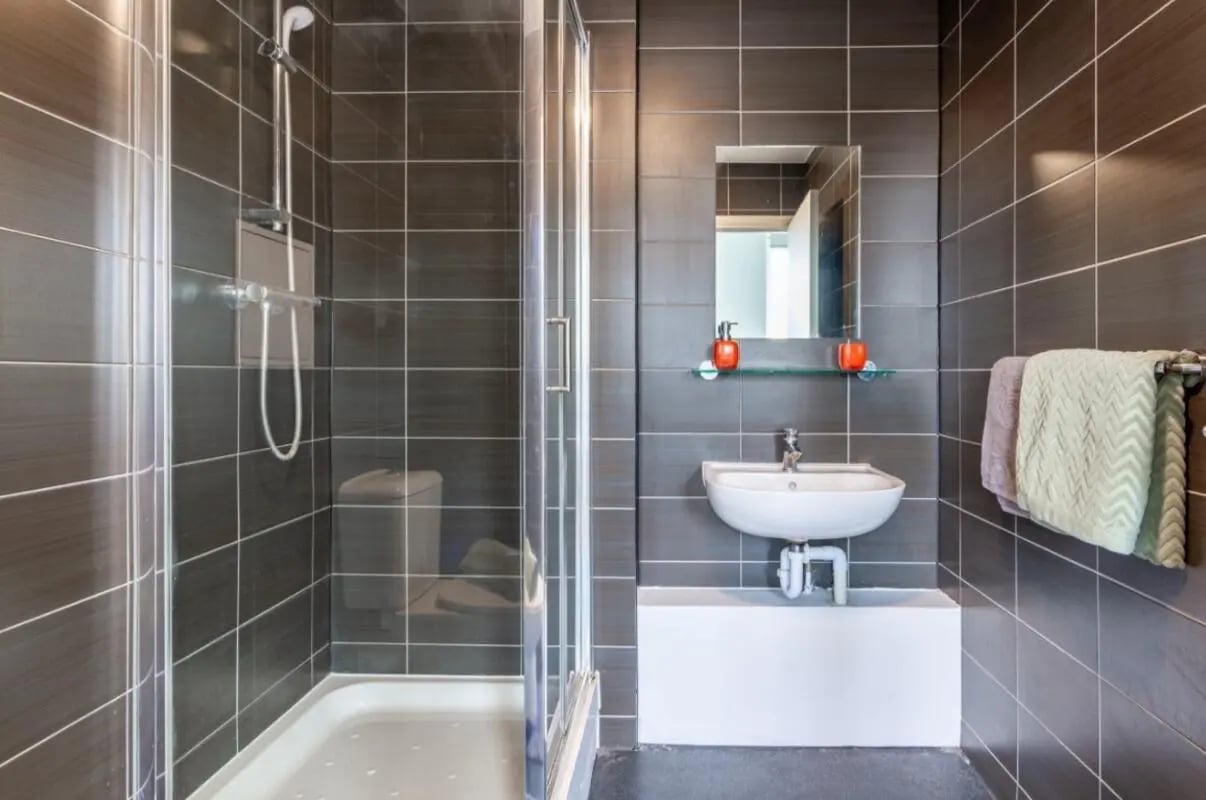 Glass shower sink mirror and towels bathroom at Portobello Garrow House in London Student Accommodation
