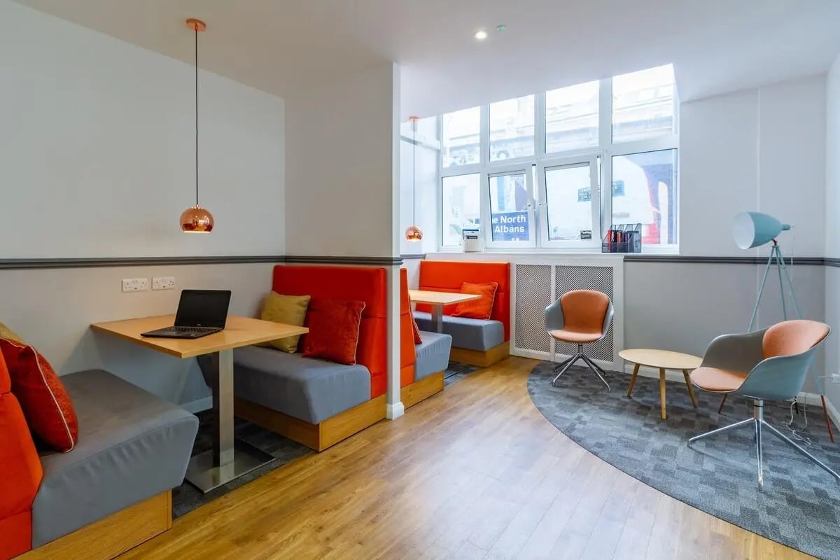 Booth seating laptop and chairs communal area at Portobello Garrow House in London Student Accommodation