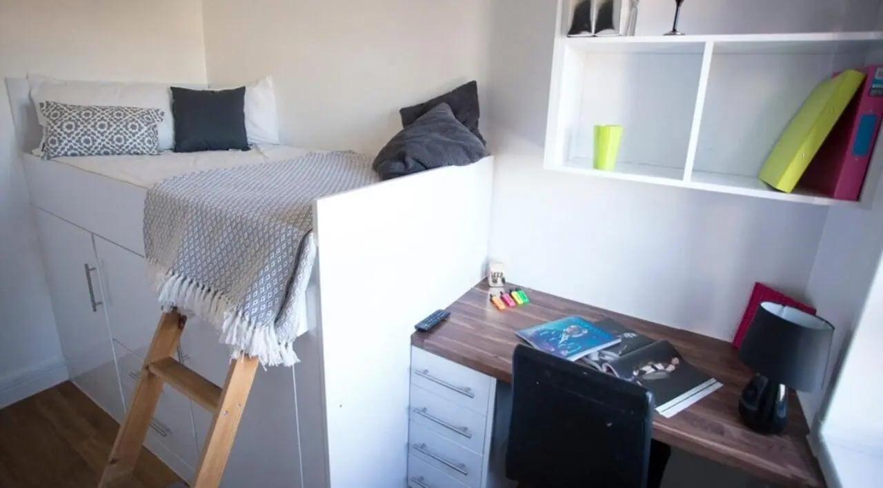 Loft bed desk lamp books files study area at Surrey Quays Landale House in London Student Accommodation