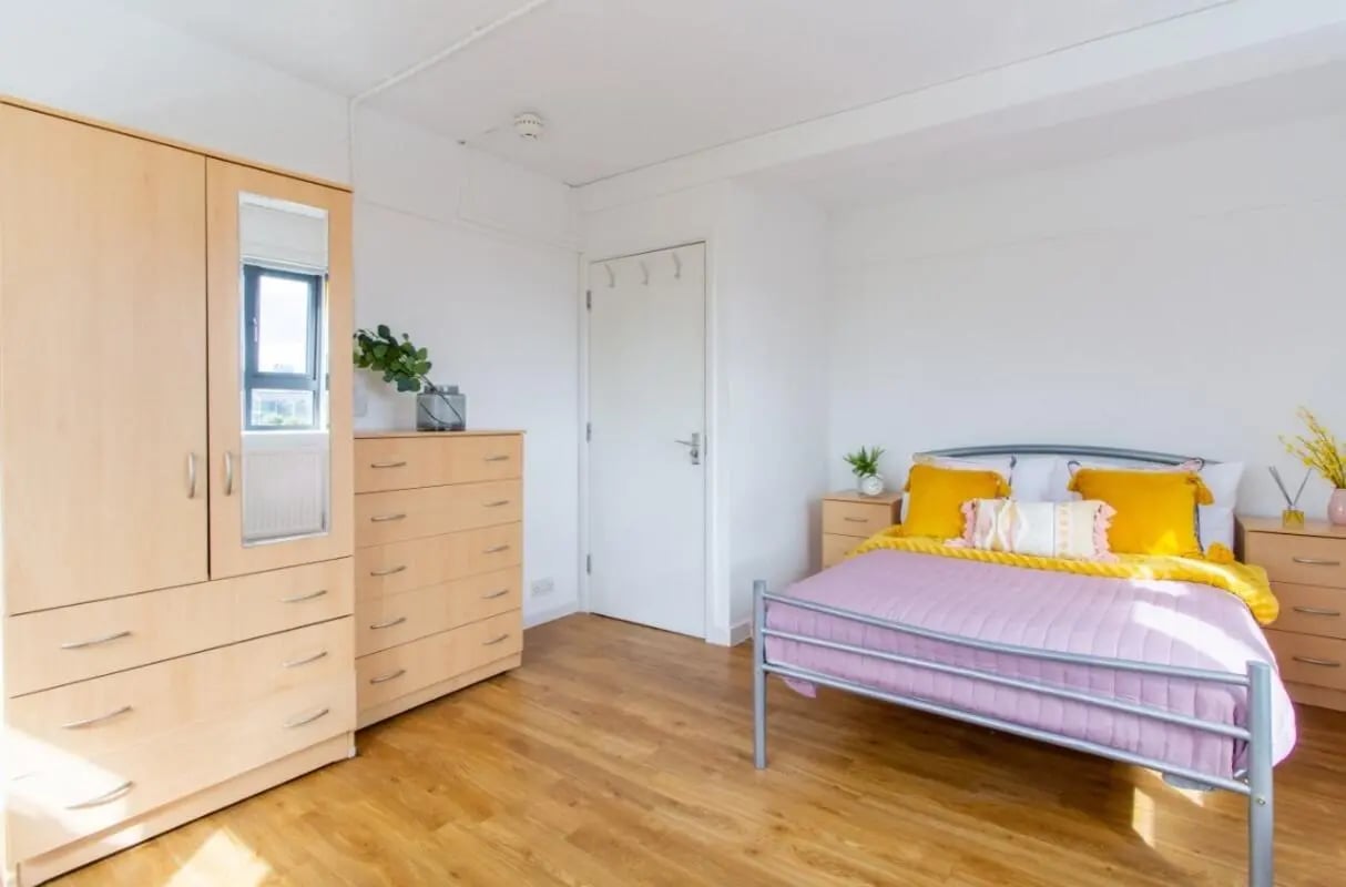 Wardrobe chest of drawers bed bedside tables bedroom at Surrey Quays Landale House in London Student Accommodation