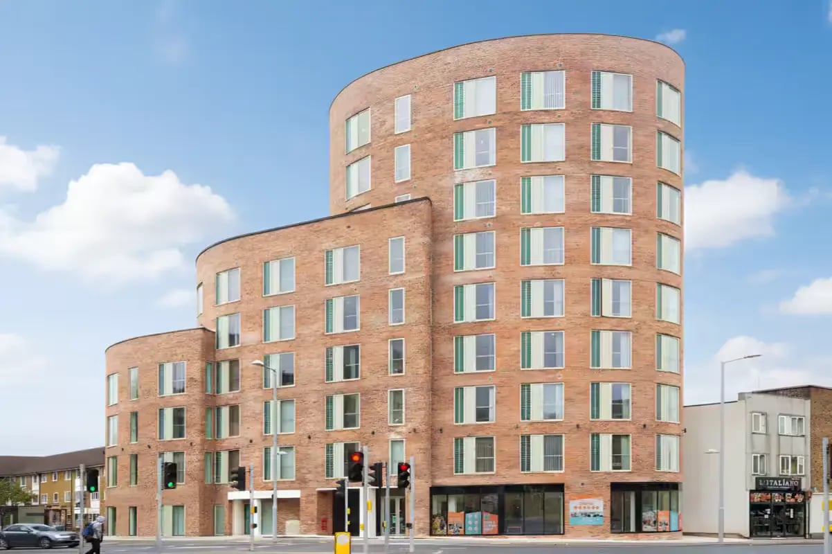 Curved brick building with many windows exterior at Orbital in Nottingham Student Accommodation