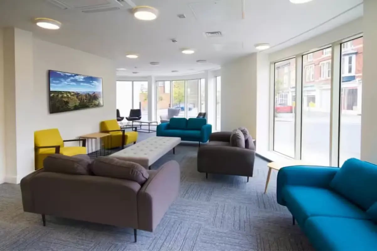 Sofas chairs bench and TV living room at Orbital in Nottingham Student Accommodation