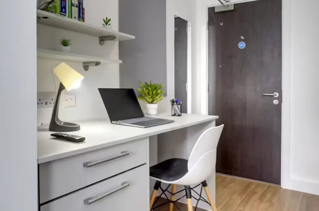 Desk with laptop lamp and chair study area at Orbital in Nottingham Student Accommodation