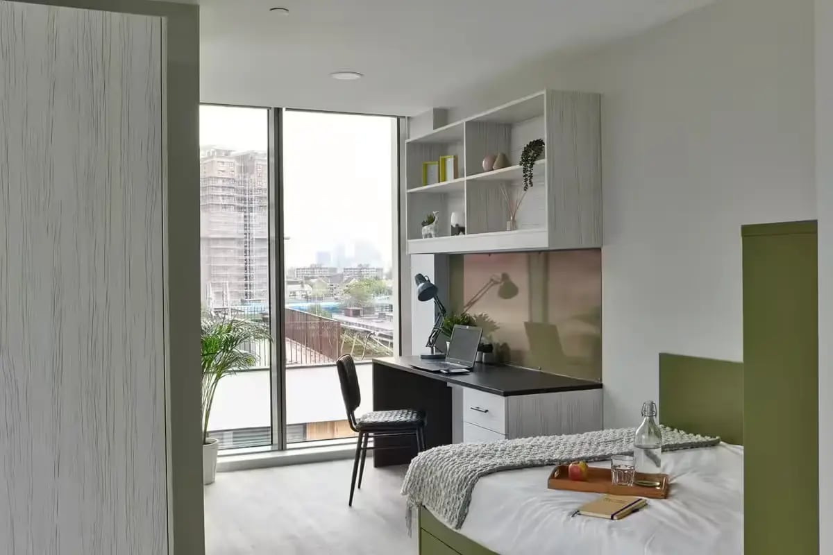 Bed with desk and shelves Student room at Flora Building - Hoxton in London Student Accommodation