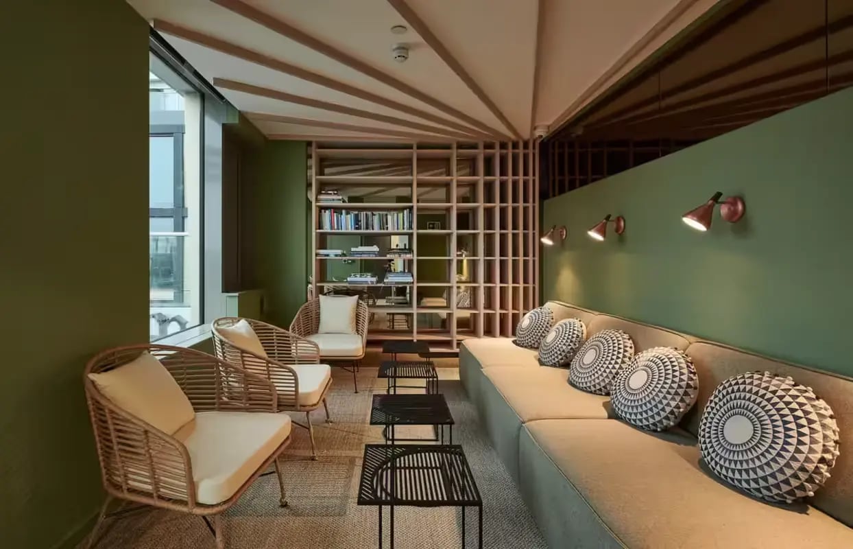 Sofa chairs and bookshelves communal area at Flora Building - Hoxton in London Student Accommodation