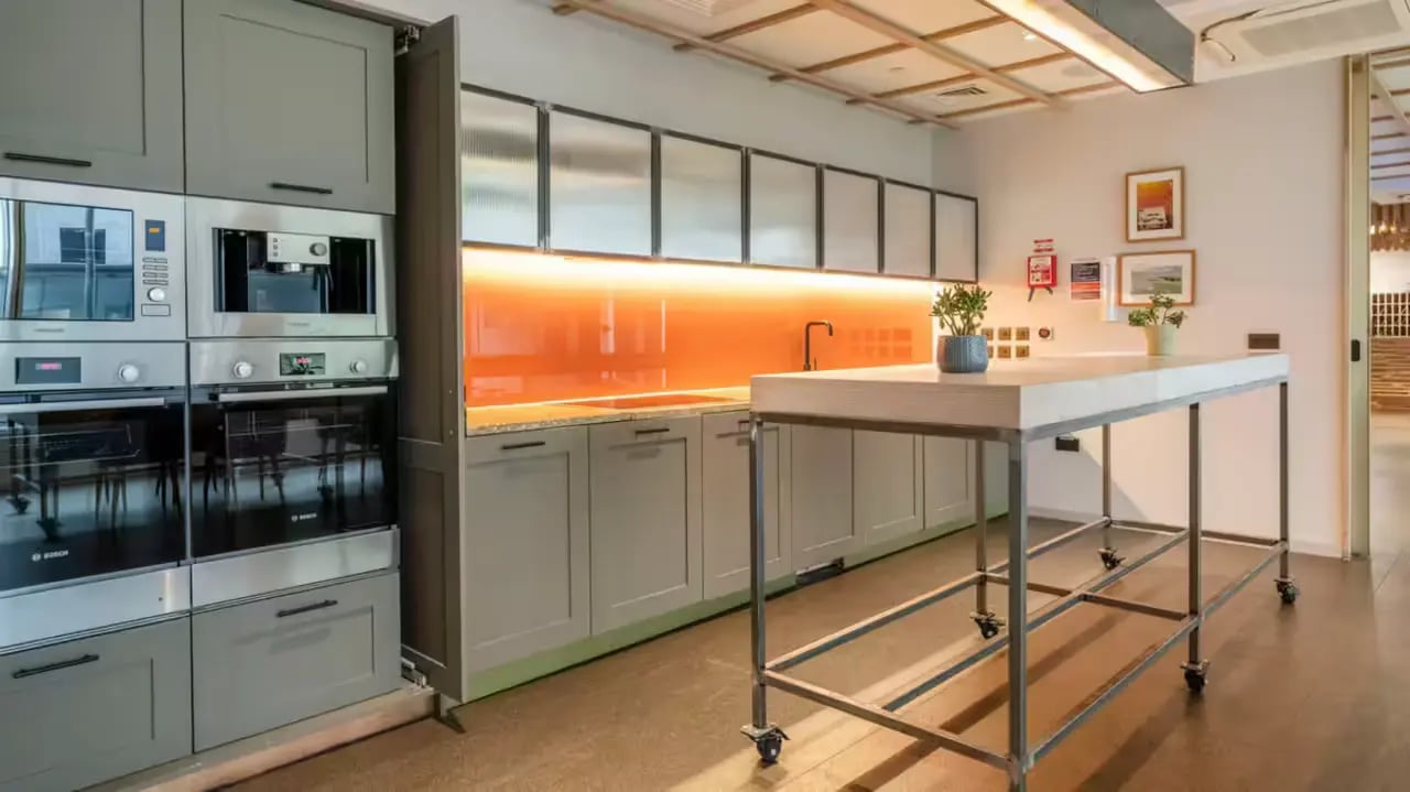 Modern kitchen with ovens coffee machine and island Kitchen at Flora Building - Hoxton in London Student Accommodation