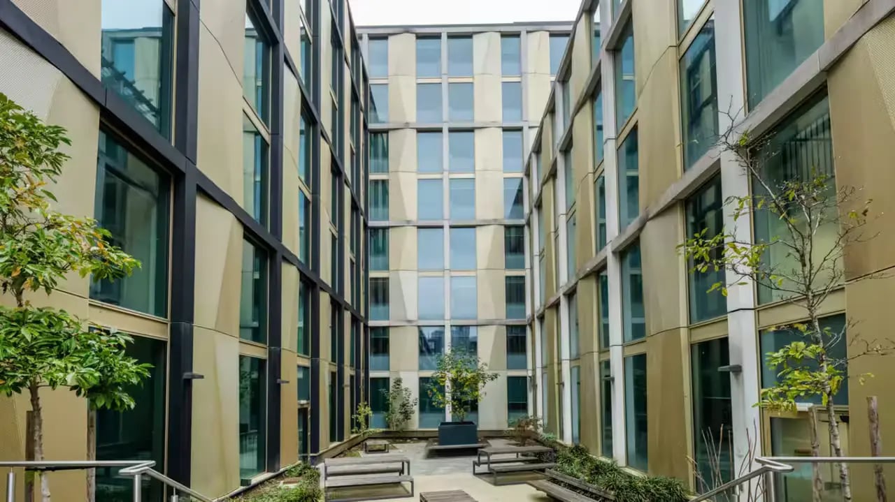 Courtyard with benches and trees exterior at Flora Building - Hoxton in London Student Accommodation