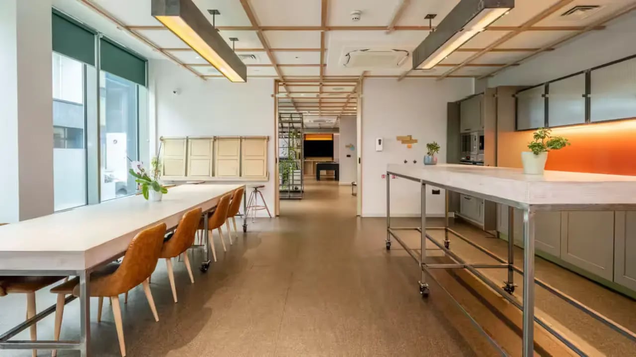 Long table with chairs kitchen area living room at Flora Building - Hoxton in London Student Accommodation