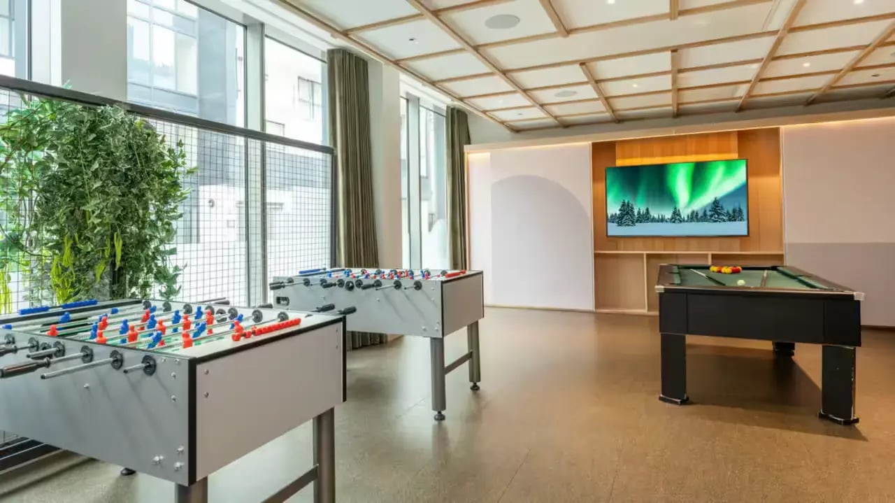 Foosball tables pool table large screen playing area at Flora Building - Hoxton in London Student Accommodation