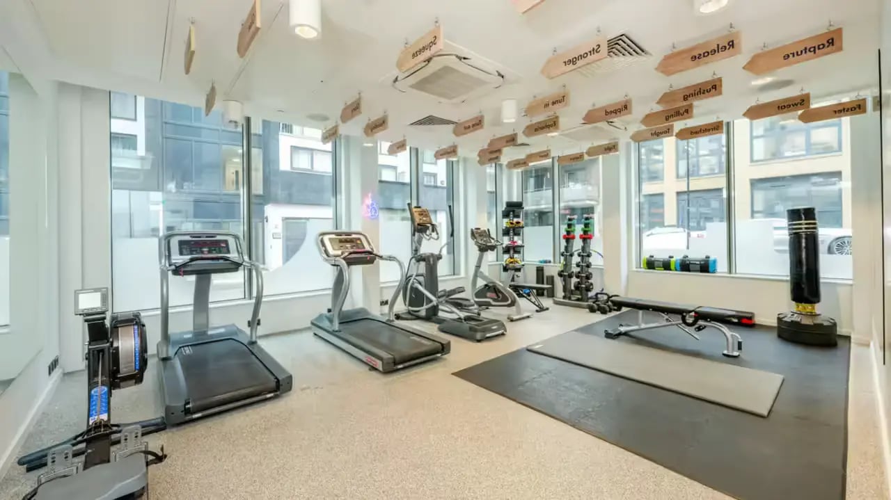 Treadmills elliptical rower weights punching bag gym area at Flora Building - Hoxton in London Student Accommodation