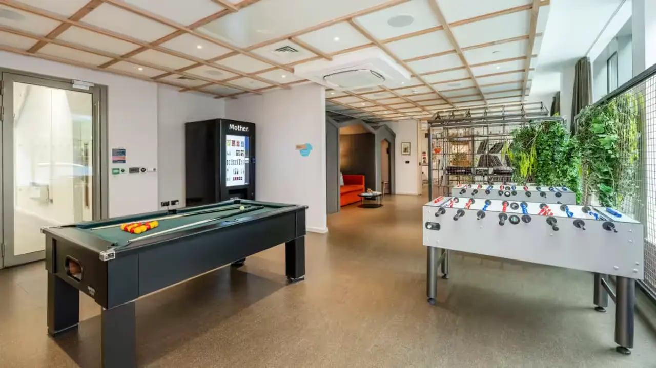 Pool table vending machine foosball tables playing area at Flora Building - Hoxton in London Student Accommodation