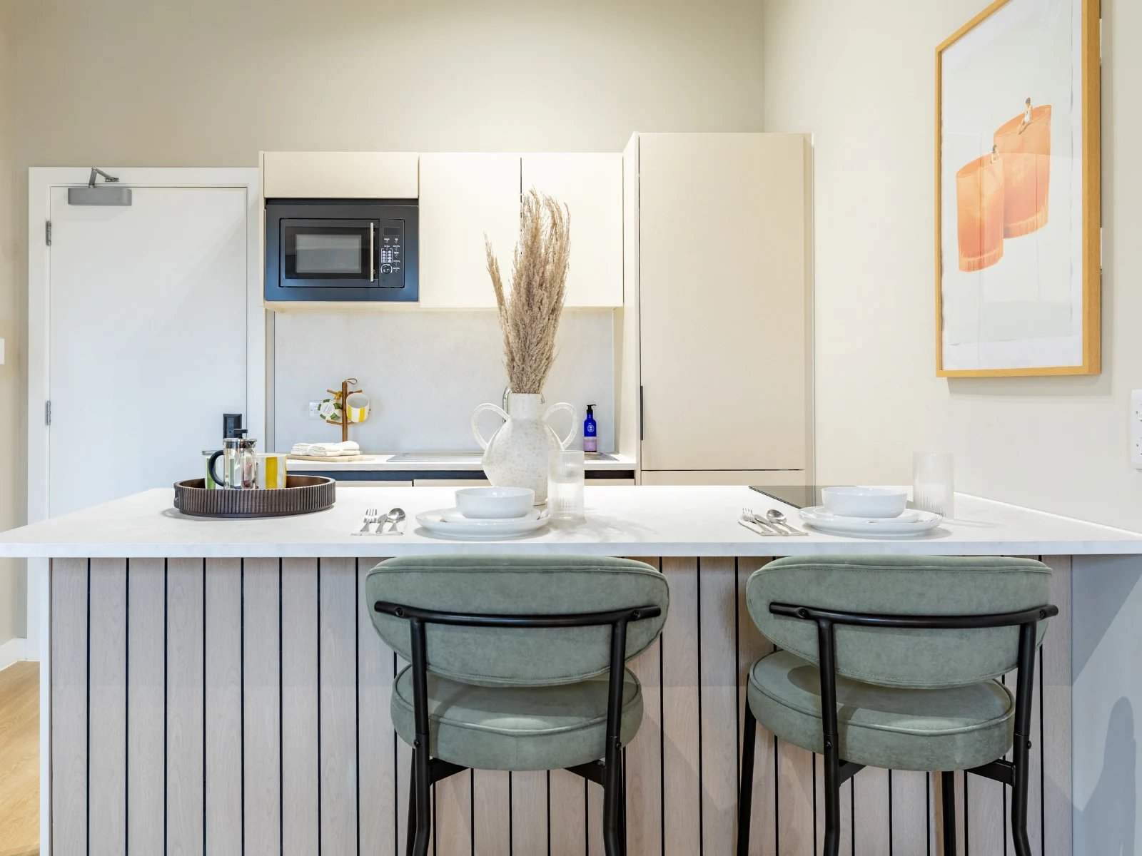 Two stools microwave and cabinets kitchen at Fitz and Knox in Cardiff Student Accommodation