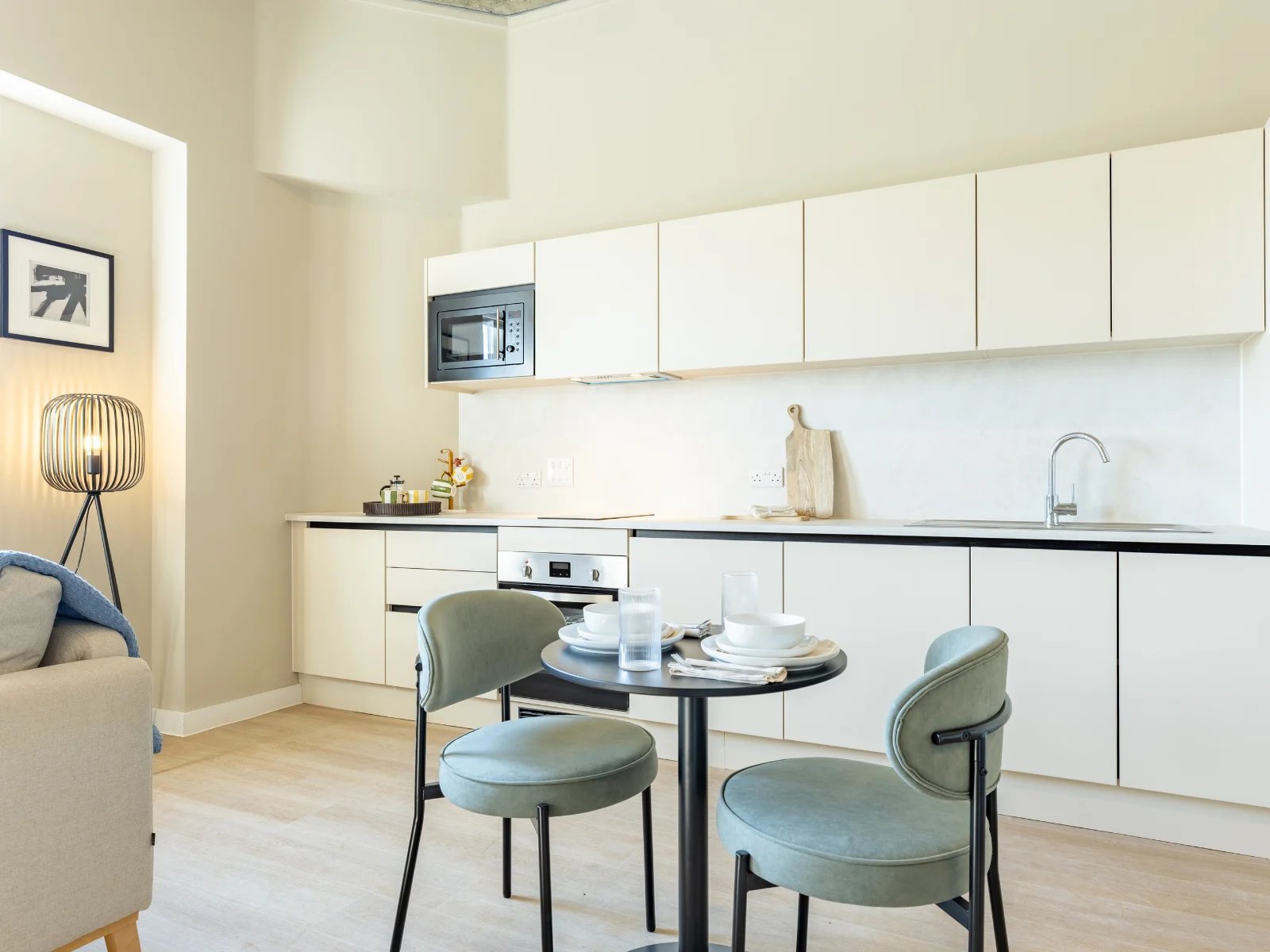 Modern white kitchen with dining table kitchen at Fitz and Knox in Cardiff Student Accommodation