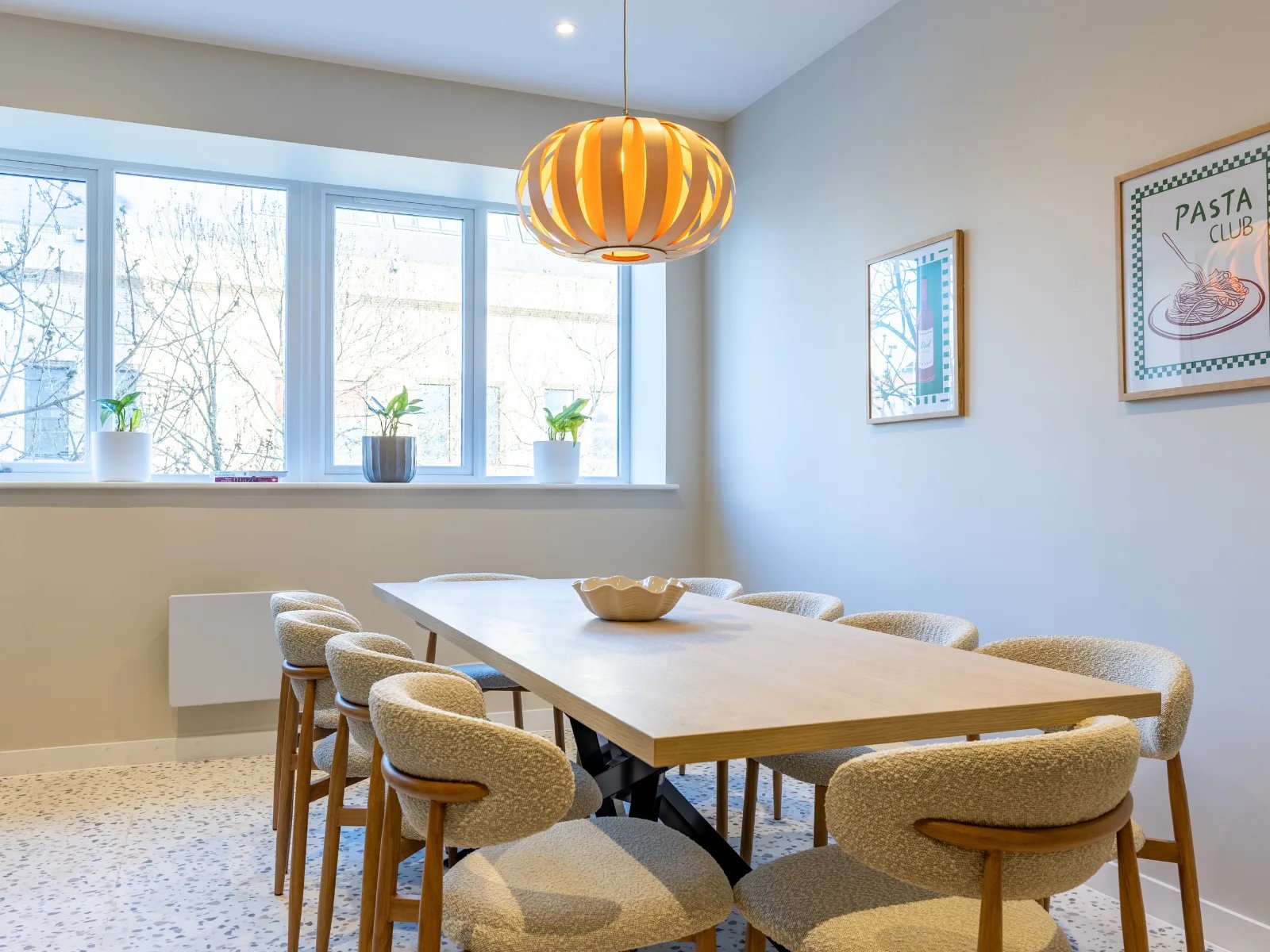 Wooden dining table with chairs and pendant light dining area at Fitz and Knox in Cardiff Student Accommodation