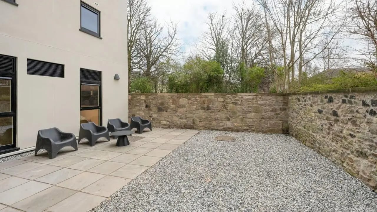 Four black chairs and table outdoor patio exterior at Straits Place in Edinburgh Student Accommodation