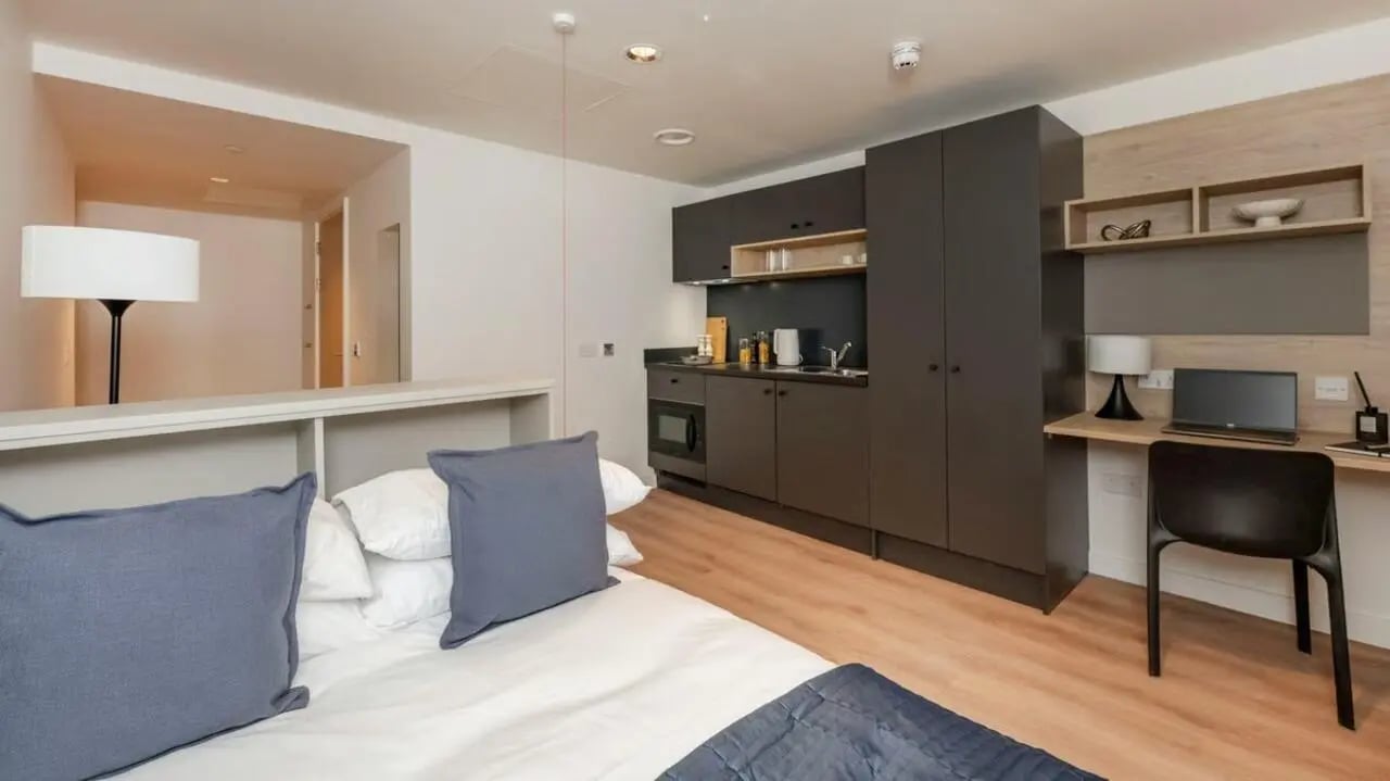 Bed kitchen desk laptop and chair Studio apartment at Straits Place in Edinburgh Student Accommodation