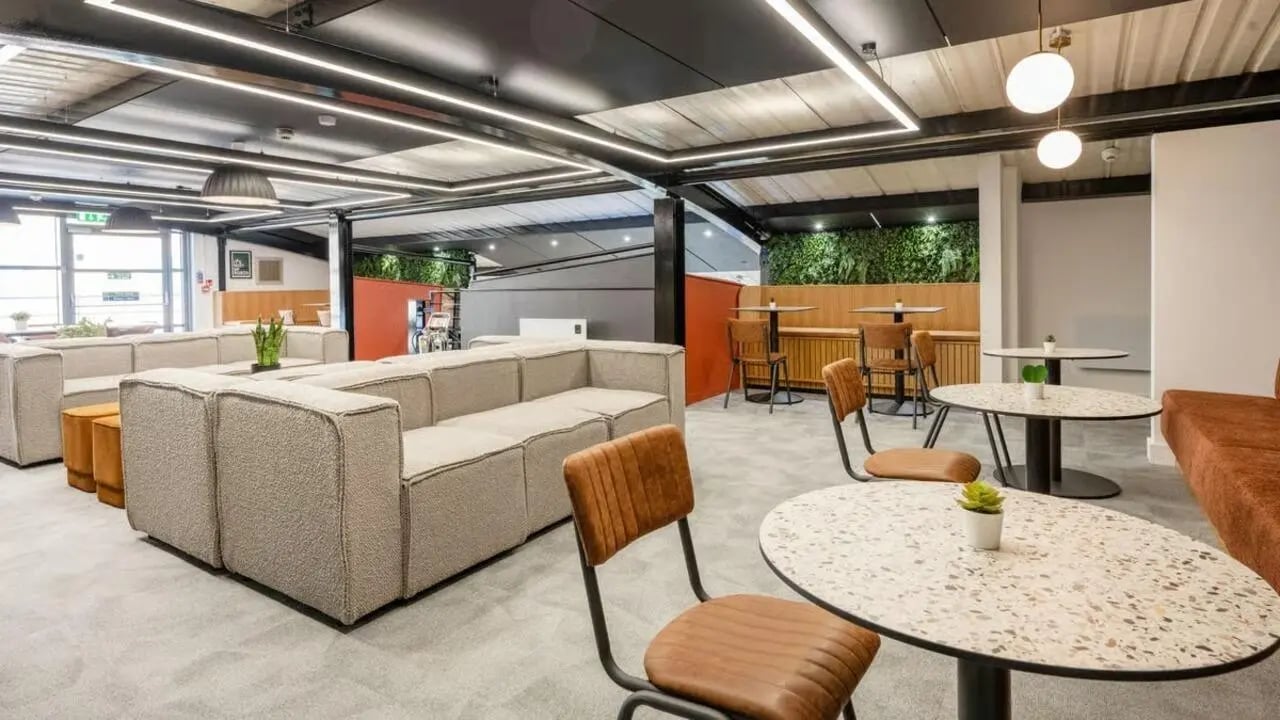 Modular sofas, tables, chairs, plants lounge area at Clarence Dock Village in Leeds Student Accommodation