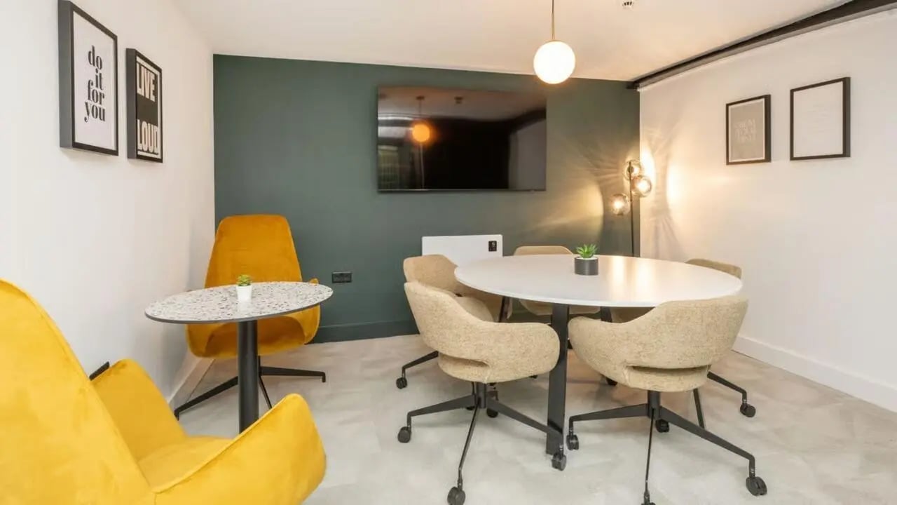 Round table chairs artwork TV common area at Clarence Dock Village in Leeds Student Accommodation