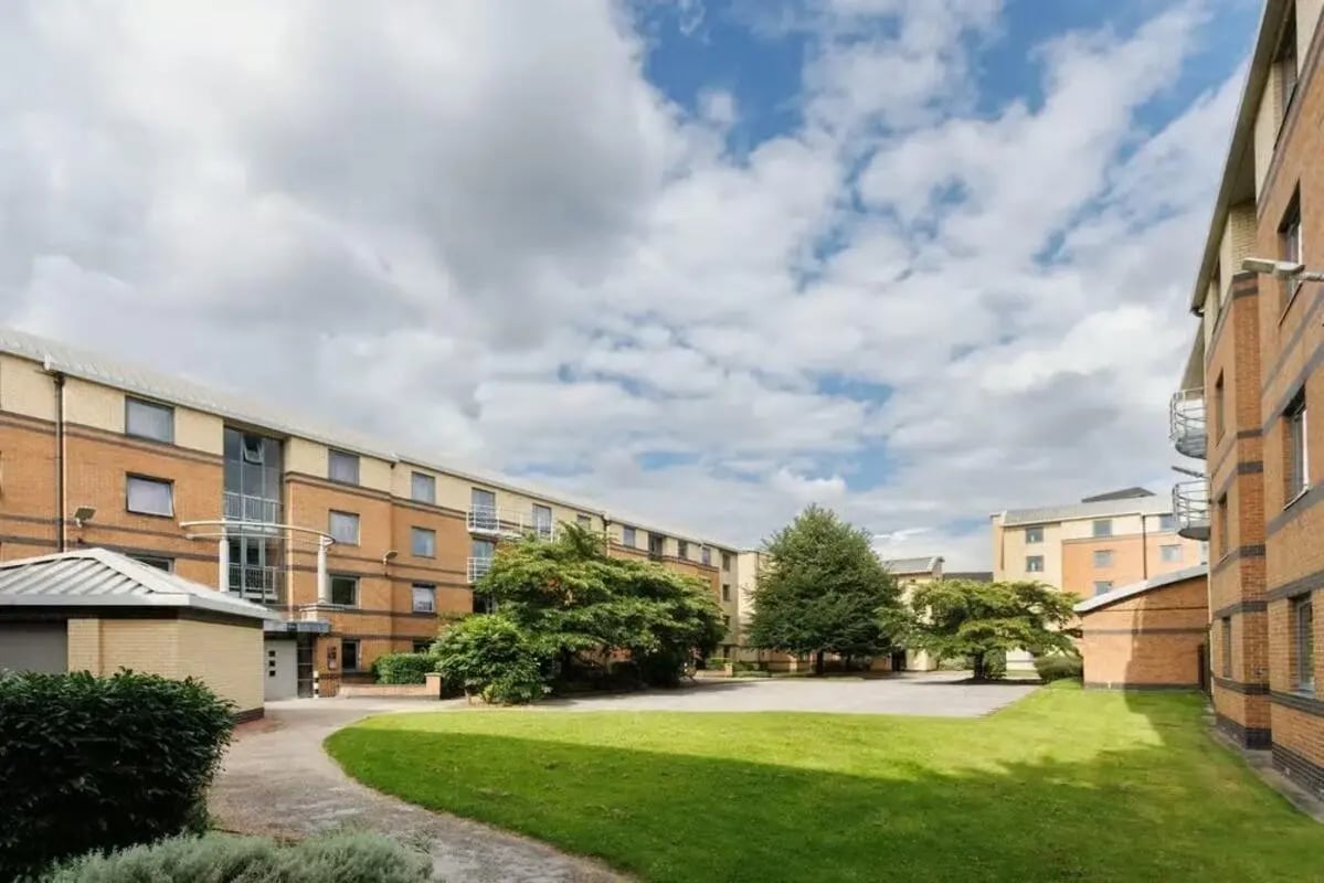 Student accommodation buildings with green lawn exterior at Clarence Dock Village in Leeds Student Accommodation