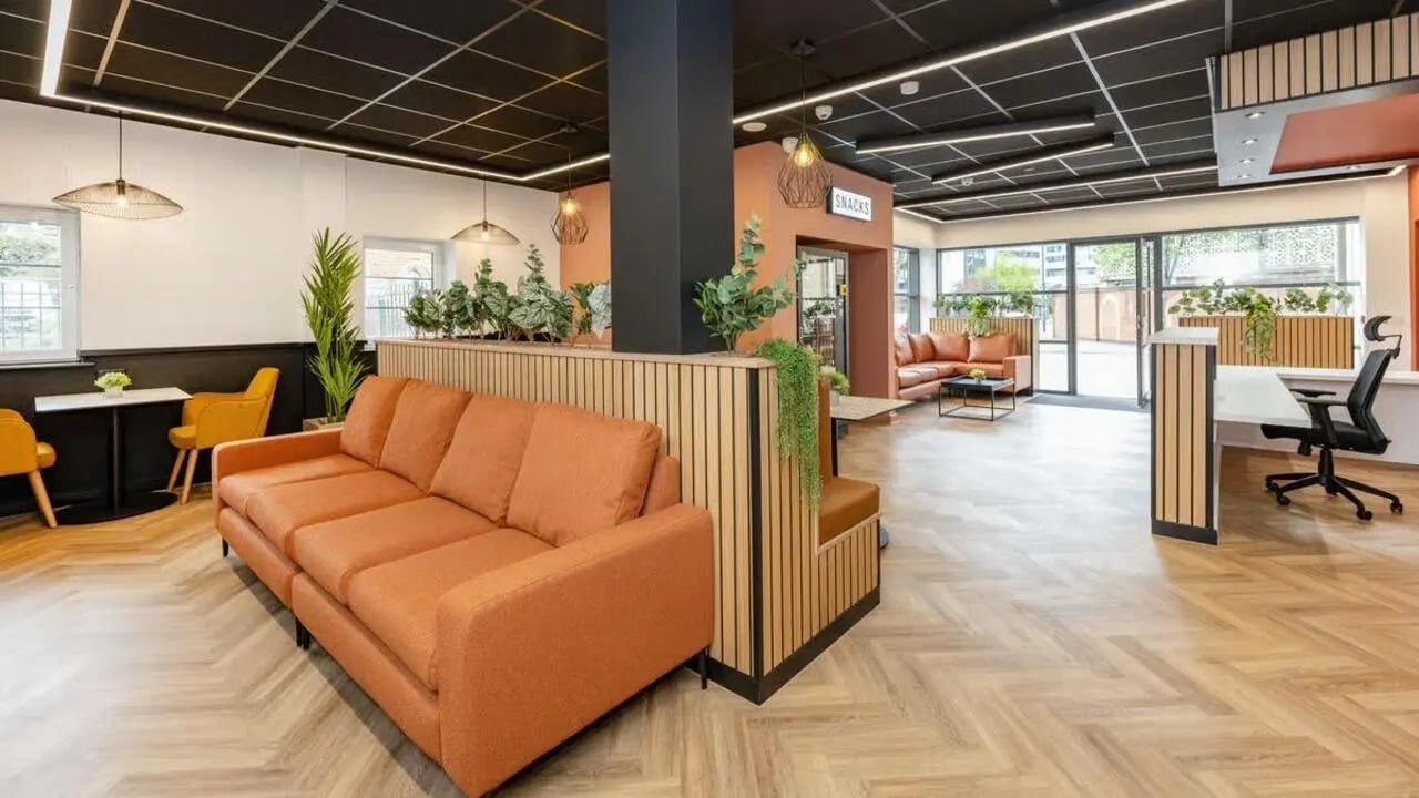 Orange sofa desk plants and seating lounge area at Curzon House in Nottingham Student Accommodation