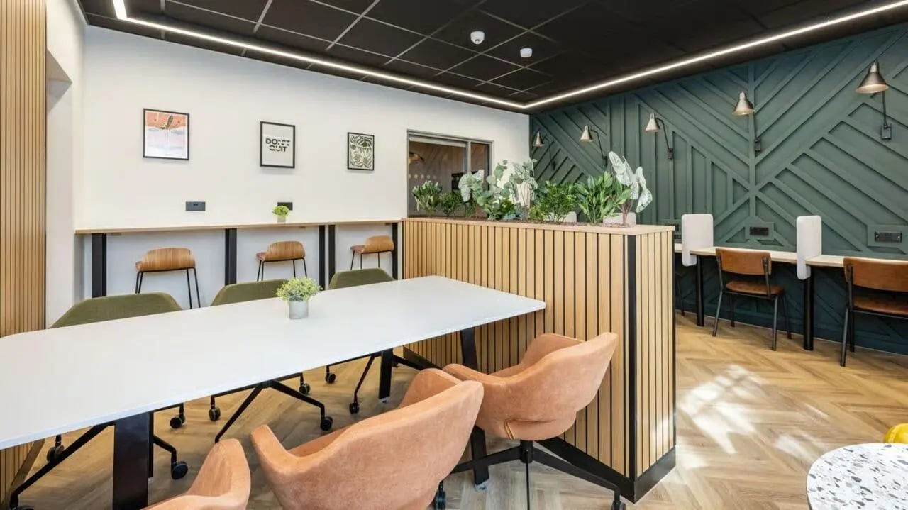 Long table chairs plants and desk study area at Curzon House in Nottingham Student Accommodation