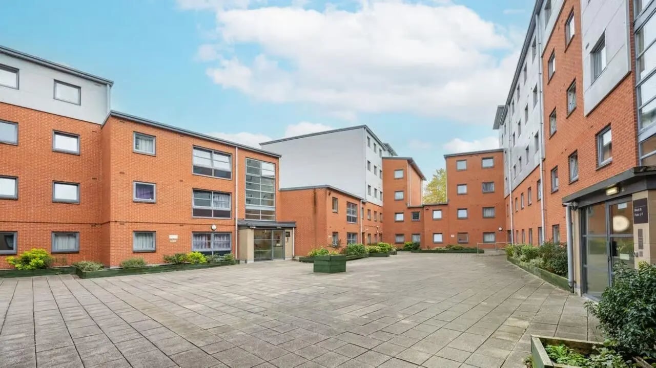 Courtyard with brick buildings and tiled paving exterior at Curzon House in Nottingham Student Accommodation