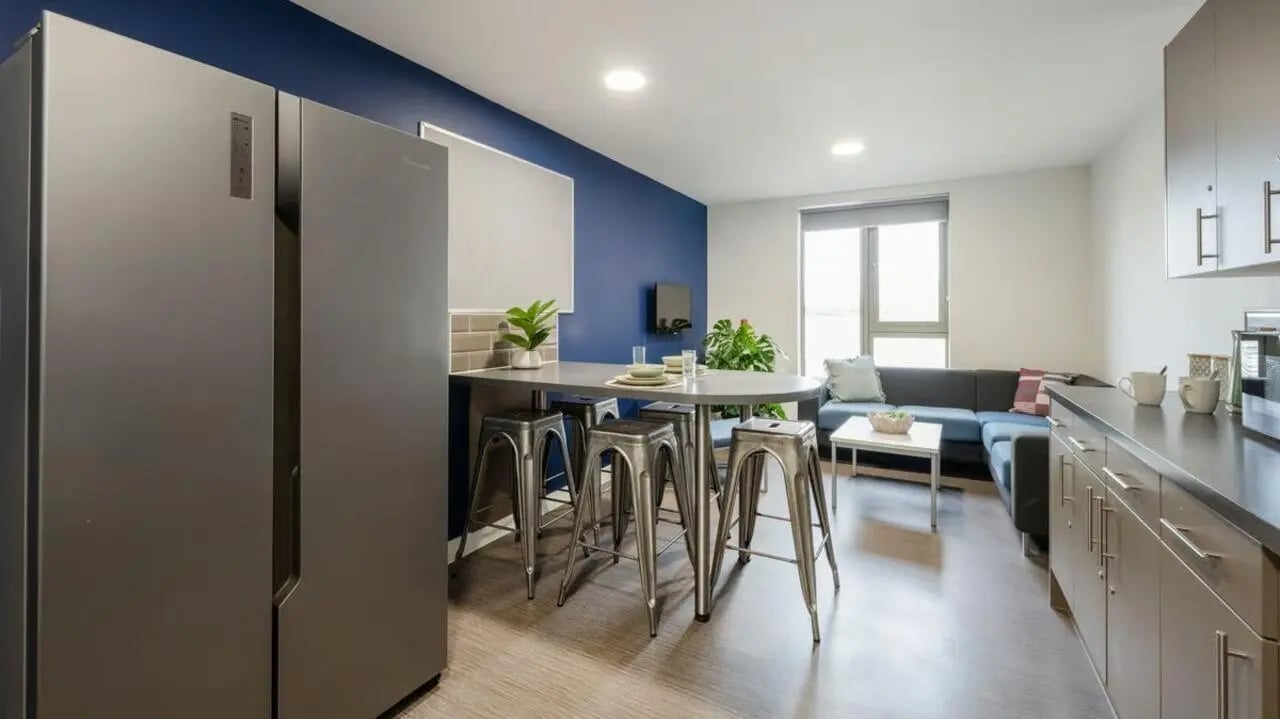 Fridge island table stools sofa kitchen living room at Foundry Courtyard in Glasgow Student Accommodation