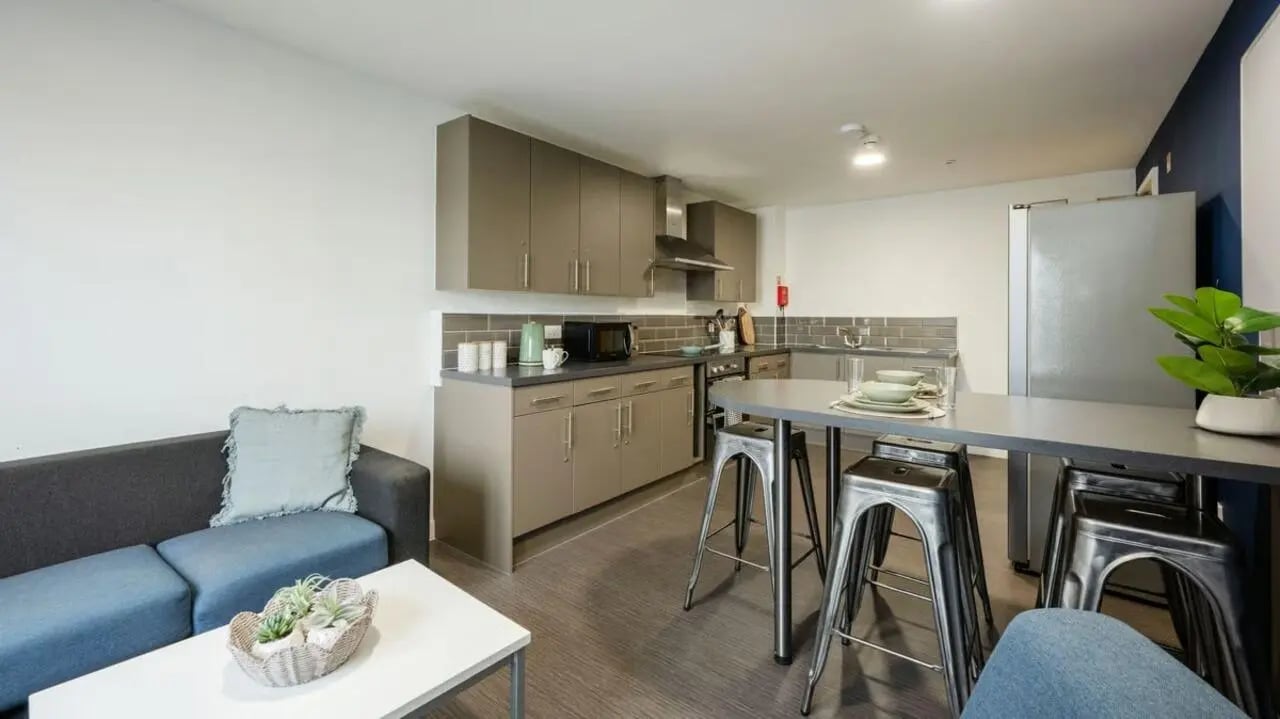 Sofa kitchen island and stools living room kitchen at Foundry Courtyard in Glasgow Student Accommodation