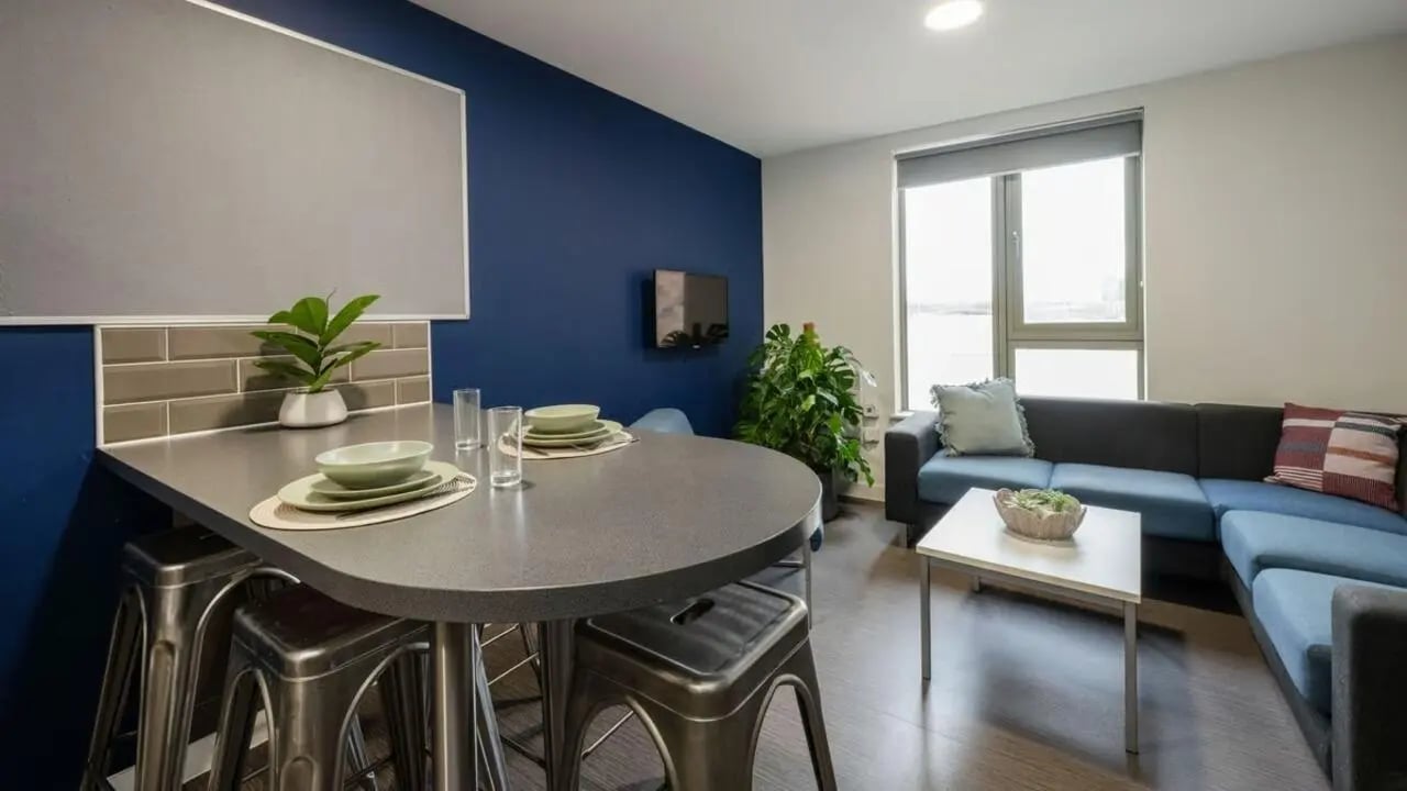 Dining bar with stools sofa coffee table living area at Foundry Courtyard in Glasgow Student Accommodation
