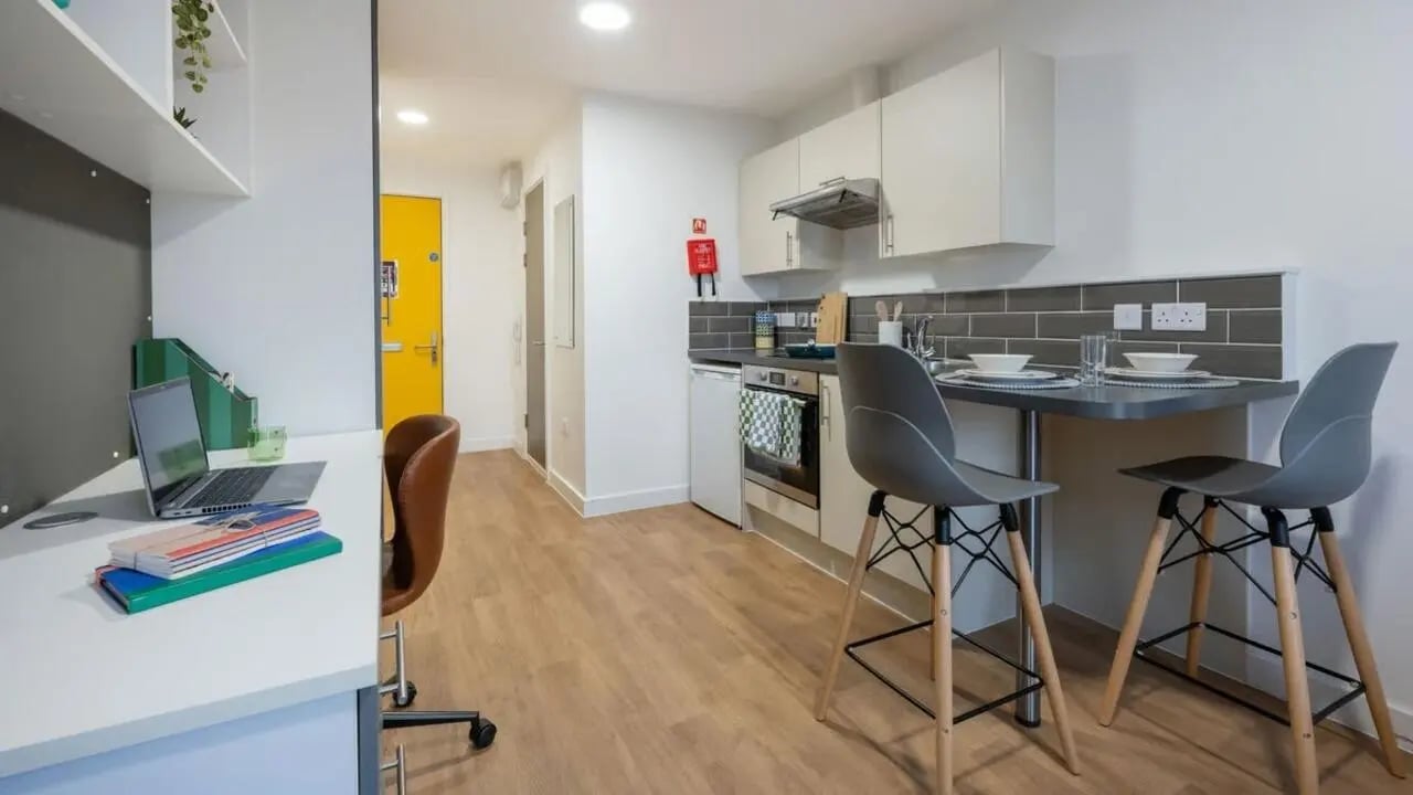 Desk laptop and kitchen area studio apartment at Foundry Courtyard in Glasgow Student Accommodation