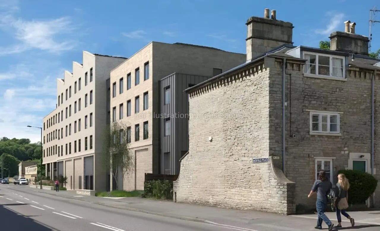 Modern apartment building next to older stone building exterior at Hollis Wharf in Bath Student Accommodation