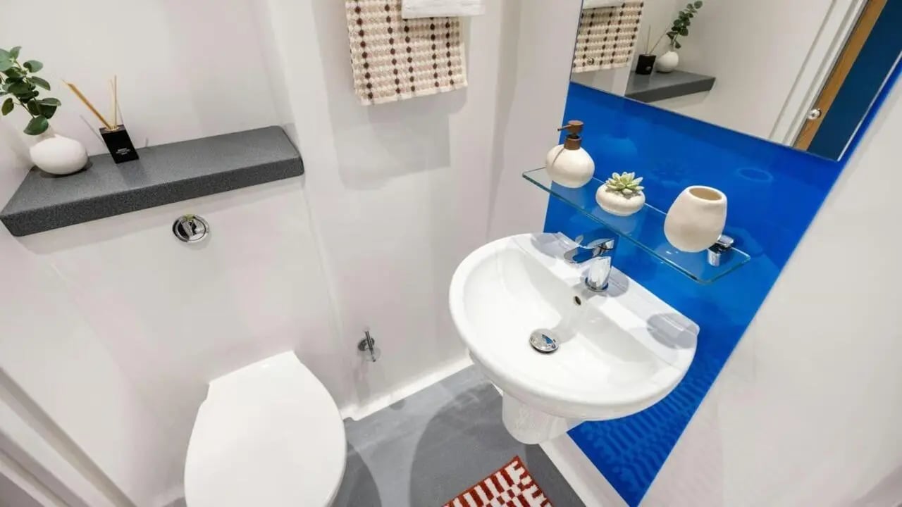 Toilet sink soap dispenser and towel bathroom at Hollis Wharf in Bath Student Accommodation