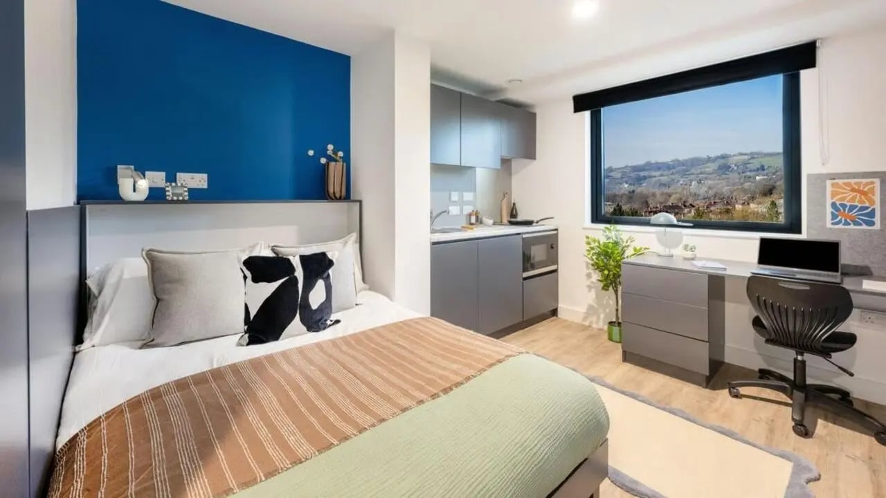 Bed desk kitchen area with large window bedroom at Hollis Wharf in Bath Student Accommodation