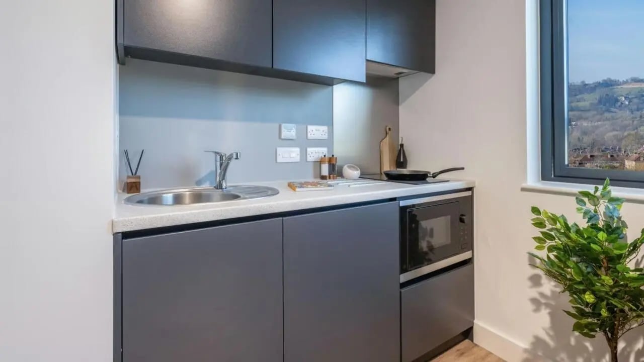 Sink microwave stove and cabinets kitchen at Hollis Wharf in Bath Student Accommodation