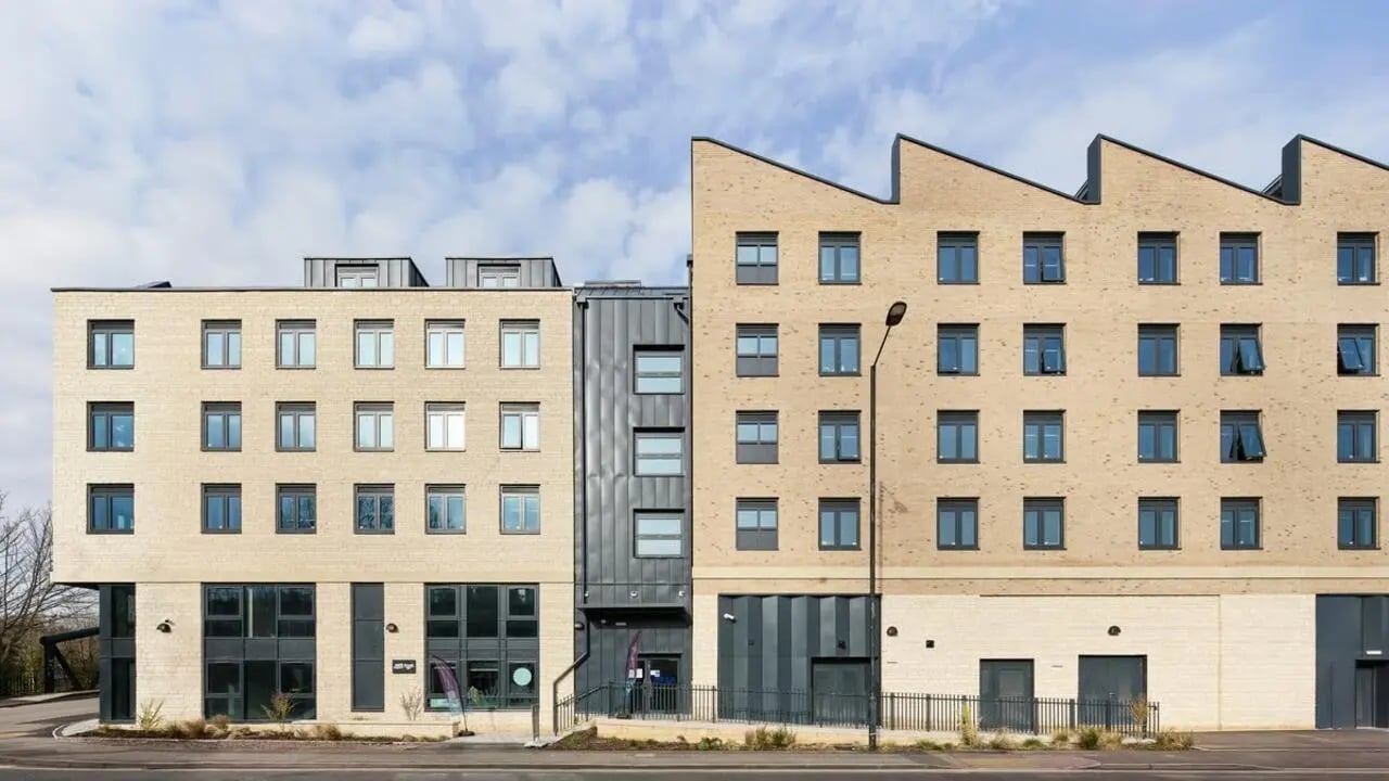 Tan brick building with many windows exterior at Hollis Wharf in Bath Student Accommodation