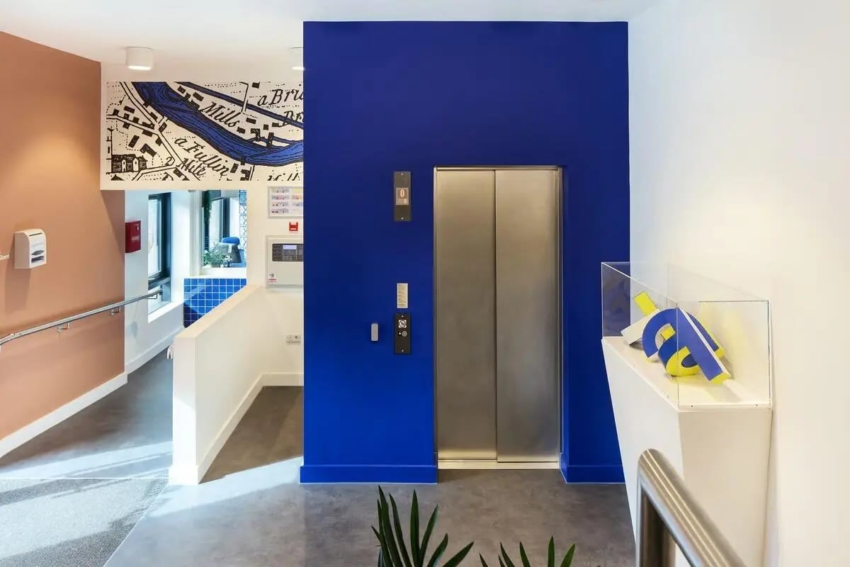 Modern elevator and map mural hallway at Hollis Wharf in Bath Student Accommodation