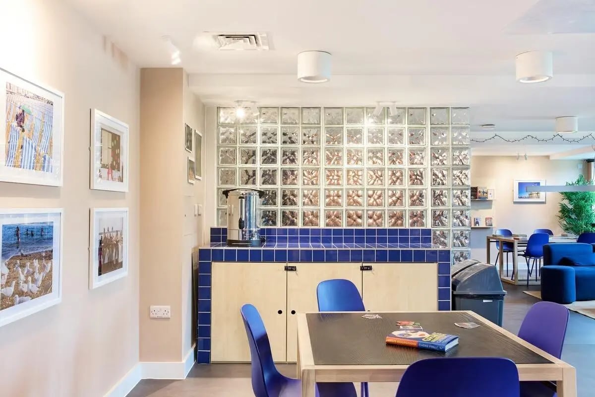 Pictures coffee urn blue table chairs lounge area at Hollis Wharf in Bath Student Accommodation