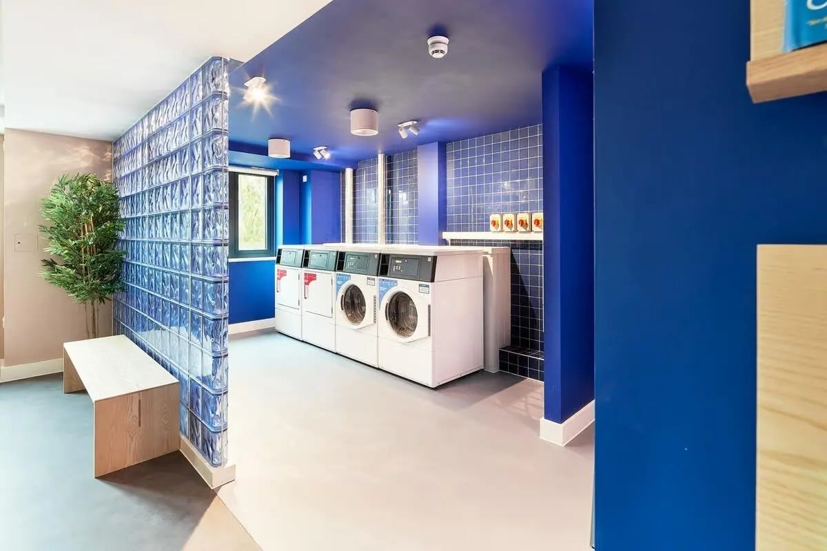 Washing machines and bench communal laundry room at Hollis Wharf in Bath Student Accommodation