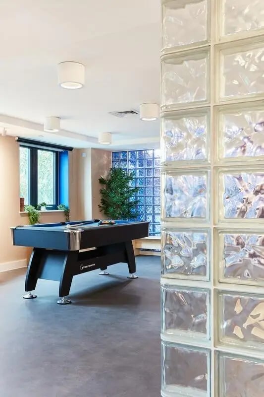 Pool table with blue felt and glass wall playing area at Hollis Wharf in Bath Student Accommodation