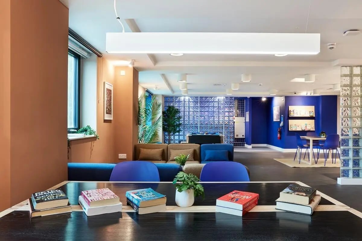 Books on table sofas seating area living room at Hollis Wharf in Bath Student Accommodation
