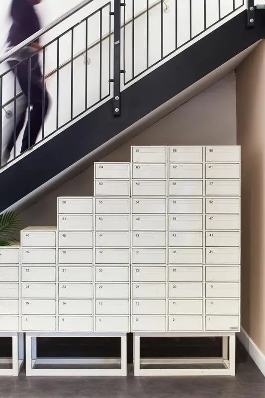 Numbered mailboxes under stairwell with person Image Type at Hollis Wharf in Bath Student Accommodation